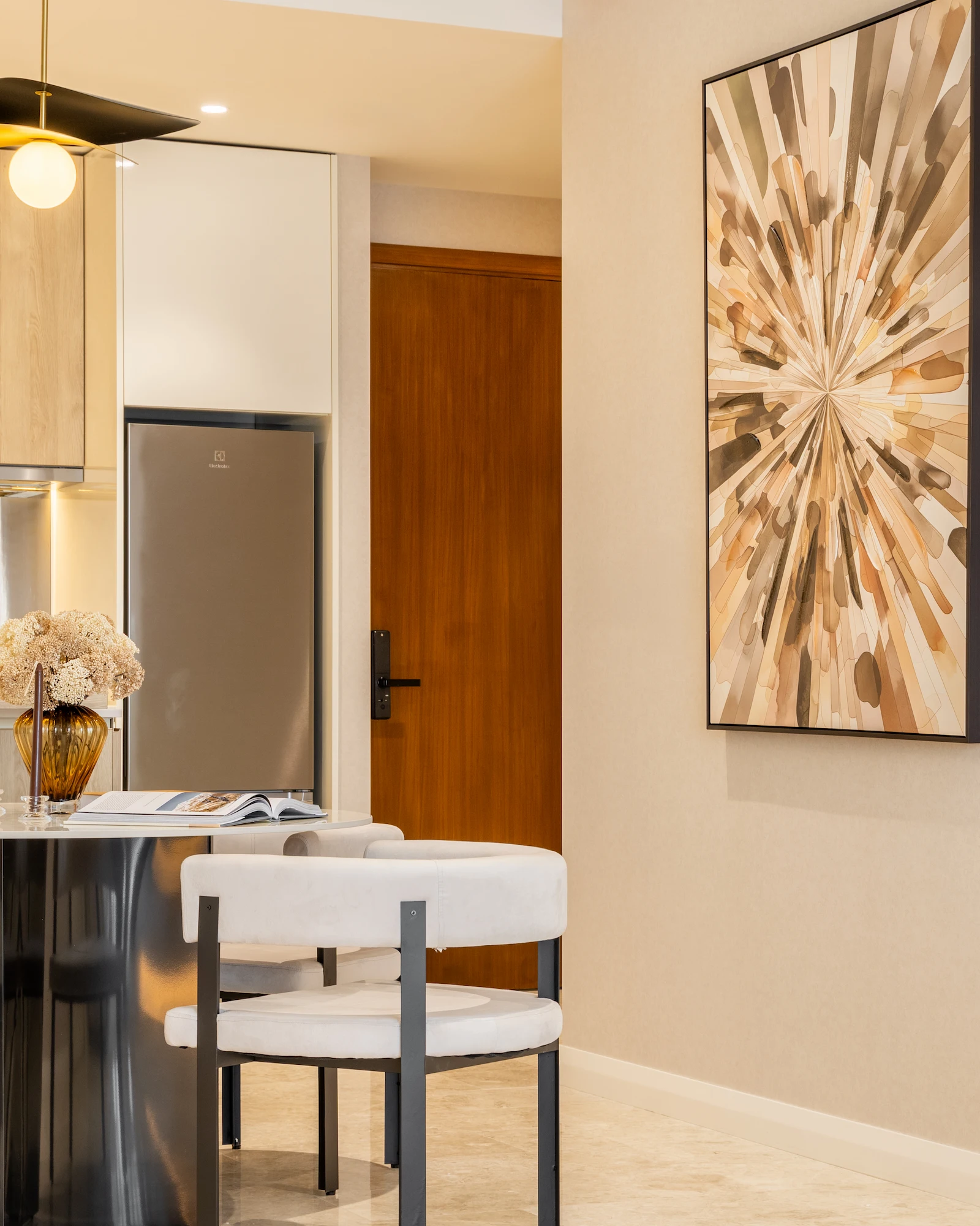 Modern dining area in TRX Residences Kuala Lumpur with reflective wall panels, stone dining table and custom chairs