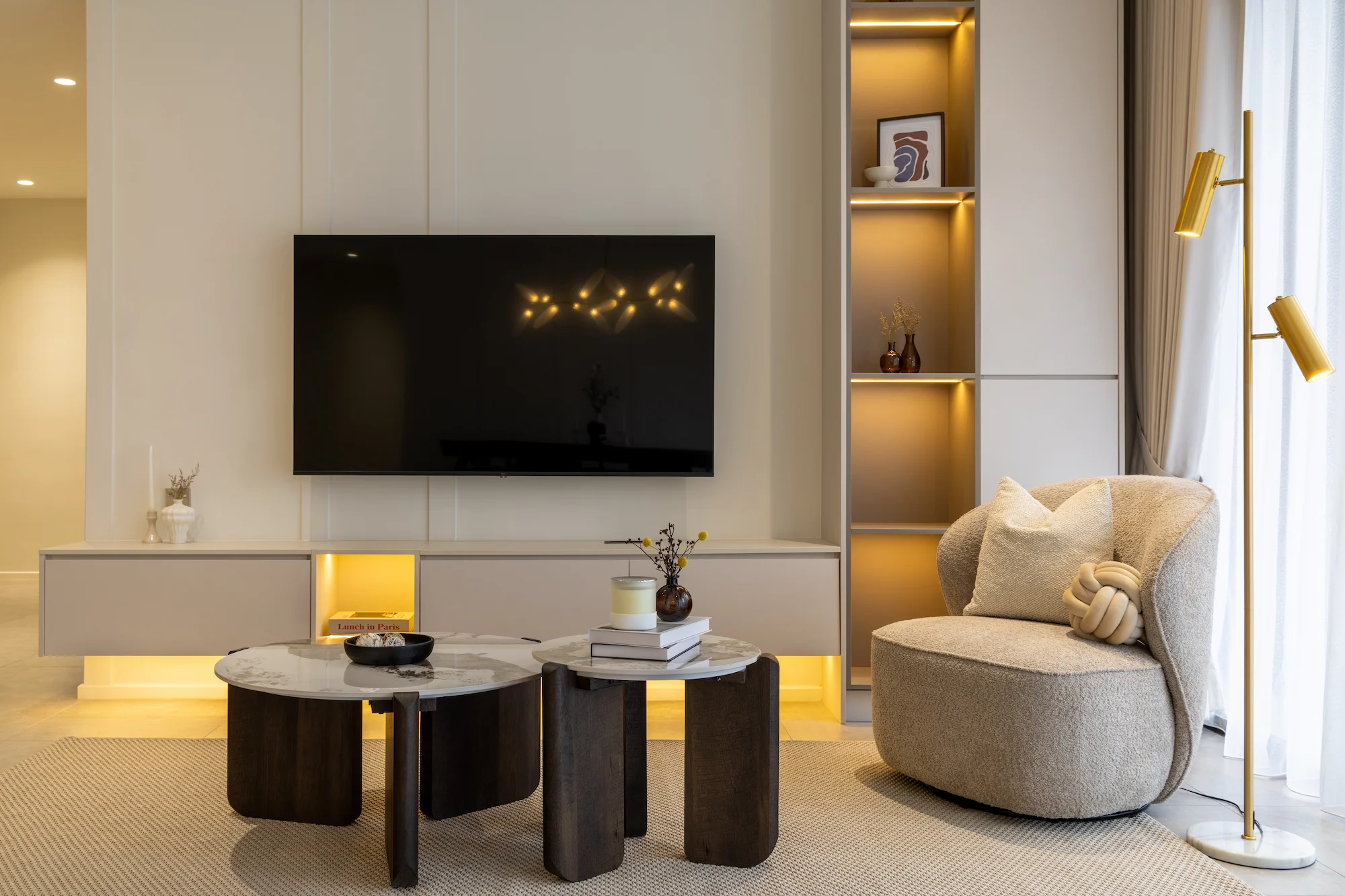 Modern living room interior design in Allevia Mont Kiara condominium, Kuala Lumpur, with custom TV feature wall, built-in shelving and neutral furnishings