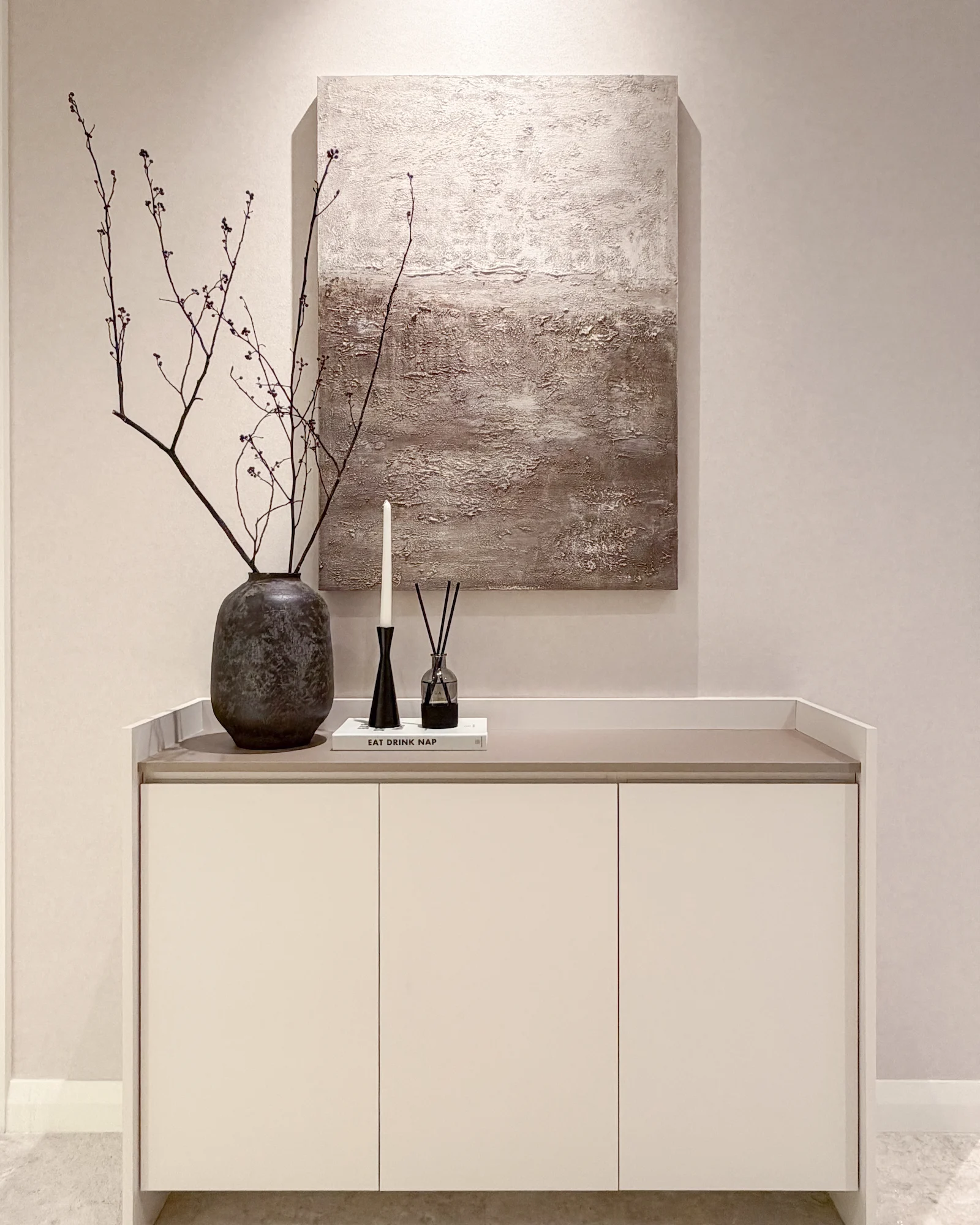 TRX Residences, Kuala Lumpur apartment entrance with custom console cabinet and textured artwork.