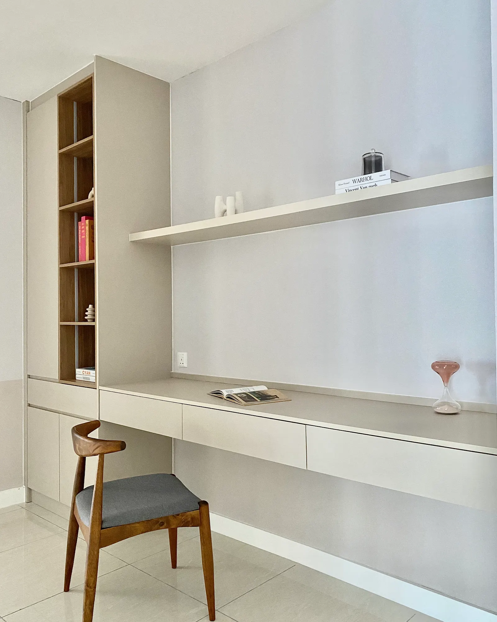 Built-in study desk and shelving with warm wood accents, open display shelves and minimalist workspace in Sentral Suites, Kuala Lumpur.