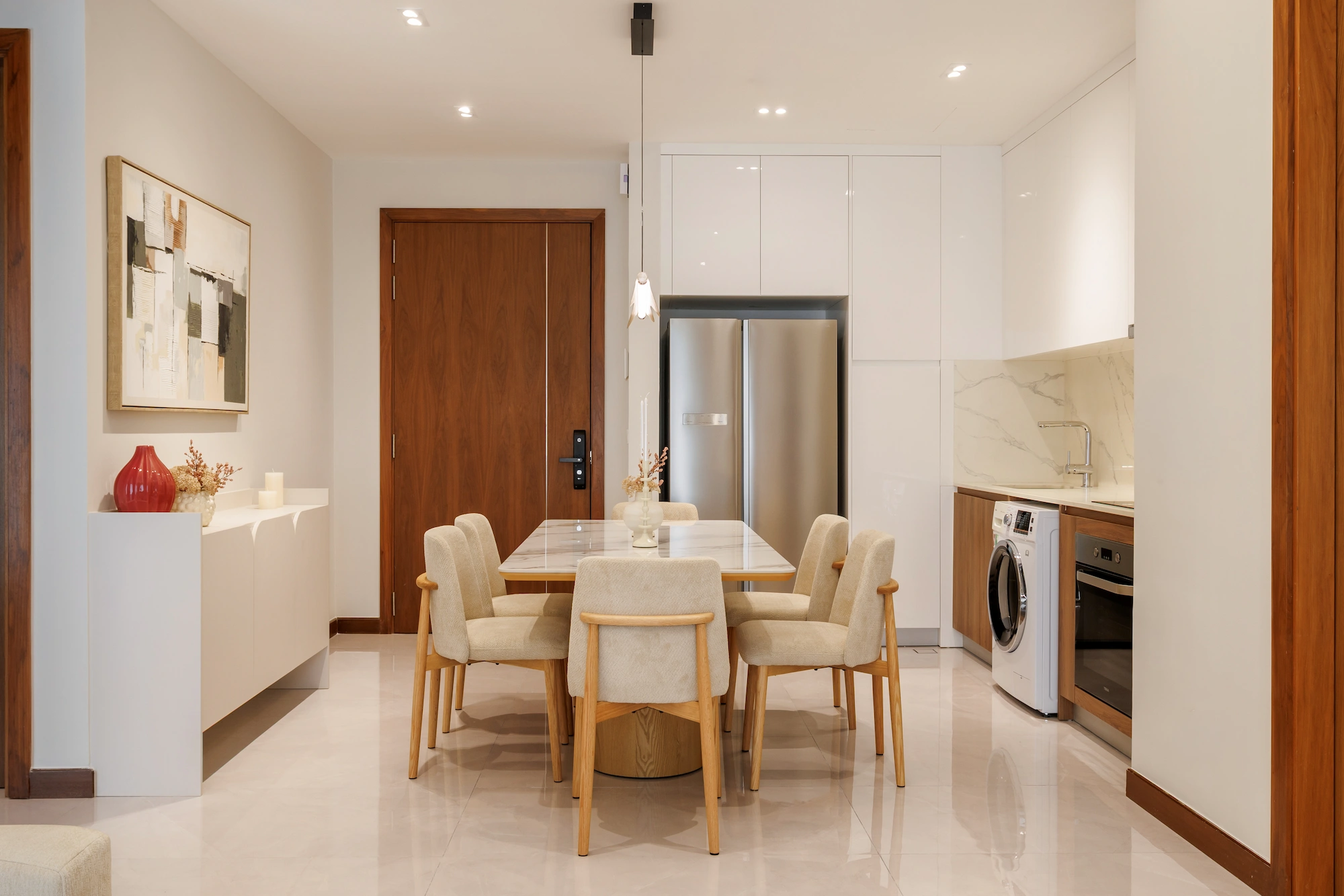 Dining area with marble table, upholstered timber chairs and sculptural pendant light
