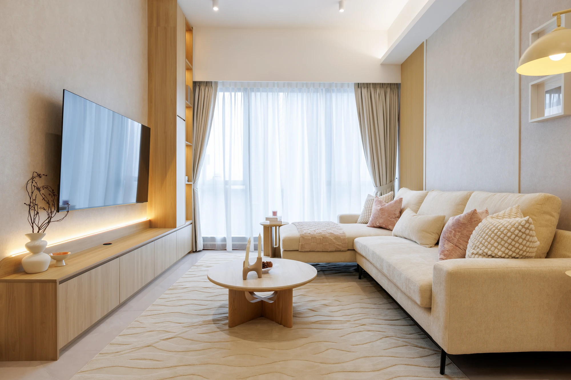 Contemporary living room with timber TV wall, curved sofa and warm concealed lighting